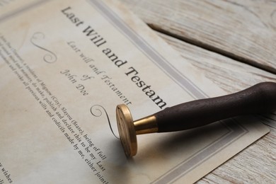 Photo of Last Will and Testament with wax stamp on wooden table, closeup