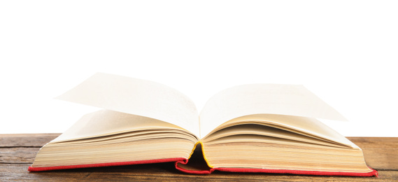 Photo of Open book on wooden table against white background