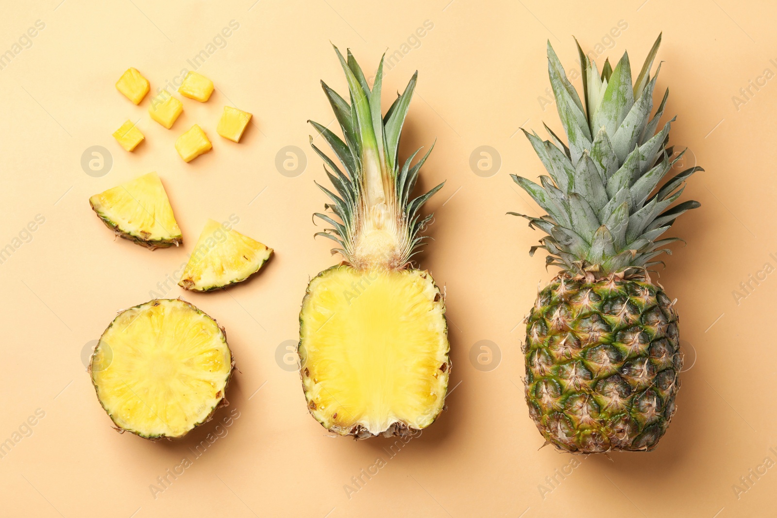 Photo of Flat lay composition with cut and fresh juicy pineapples on color background