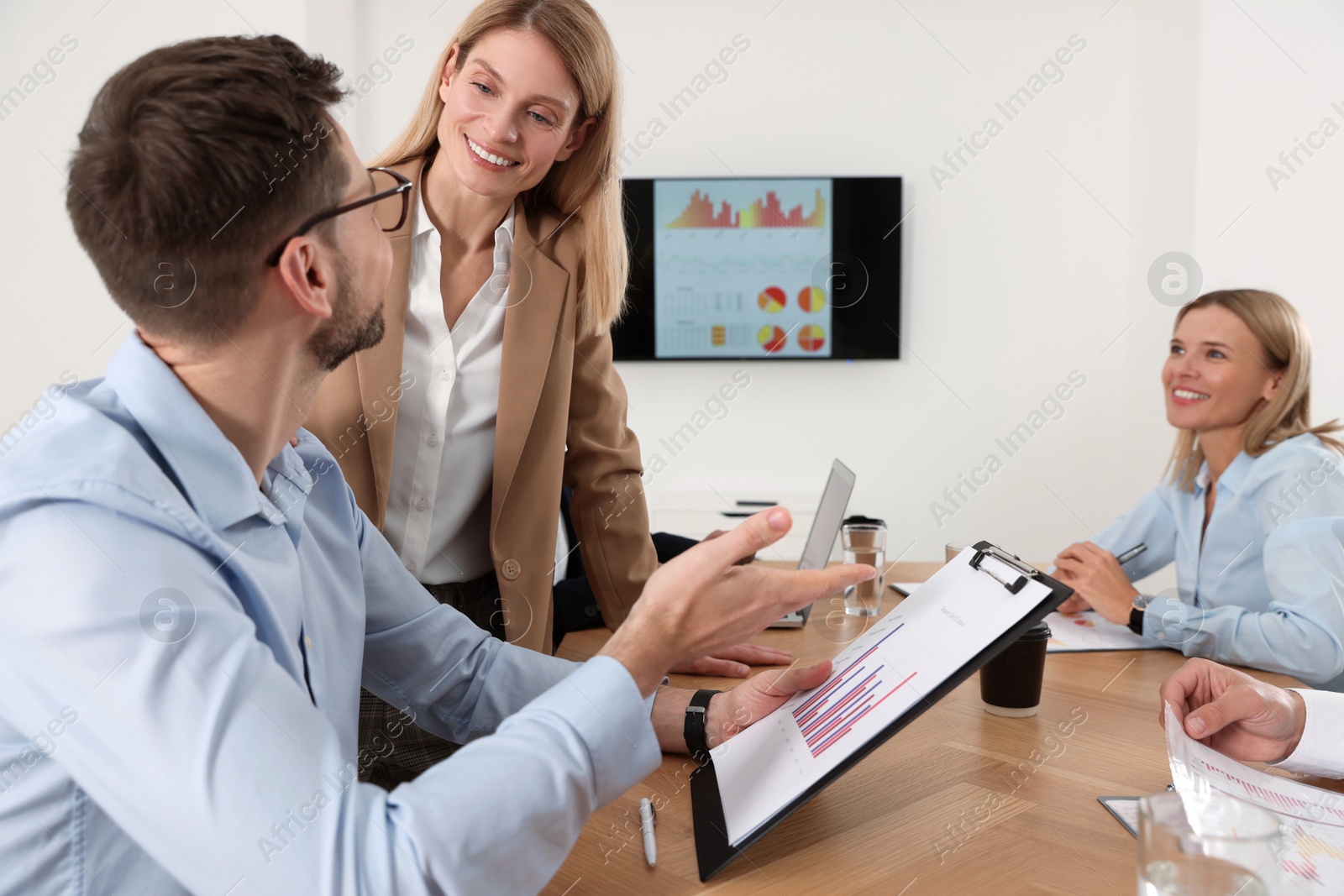 Photo of Businesswoman having meeting with her employees in office