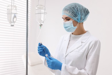 Photo of Nurse setting up IV drip in hospital