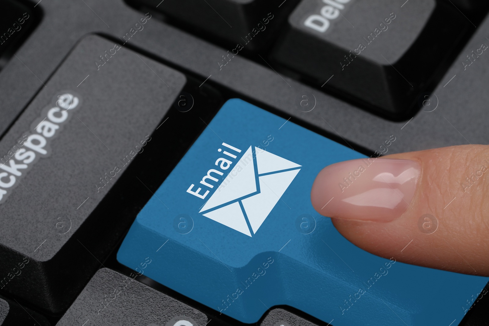 Image of Woman pressing light blue button with word Email and illustration of envelope on computer keyboard, closeup