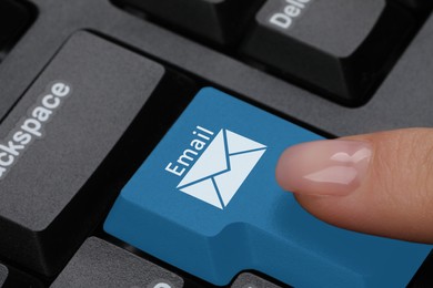 Woman pressing light blue button with word Email and illustration of envelope on computer keyboard, closeup