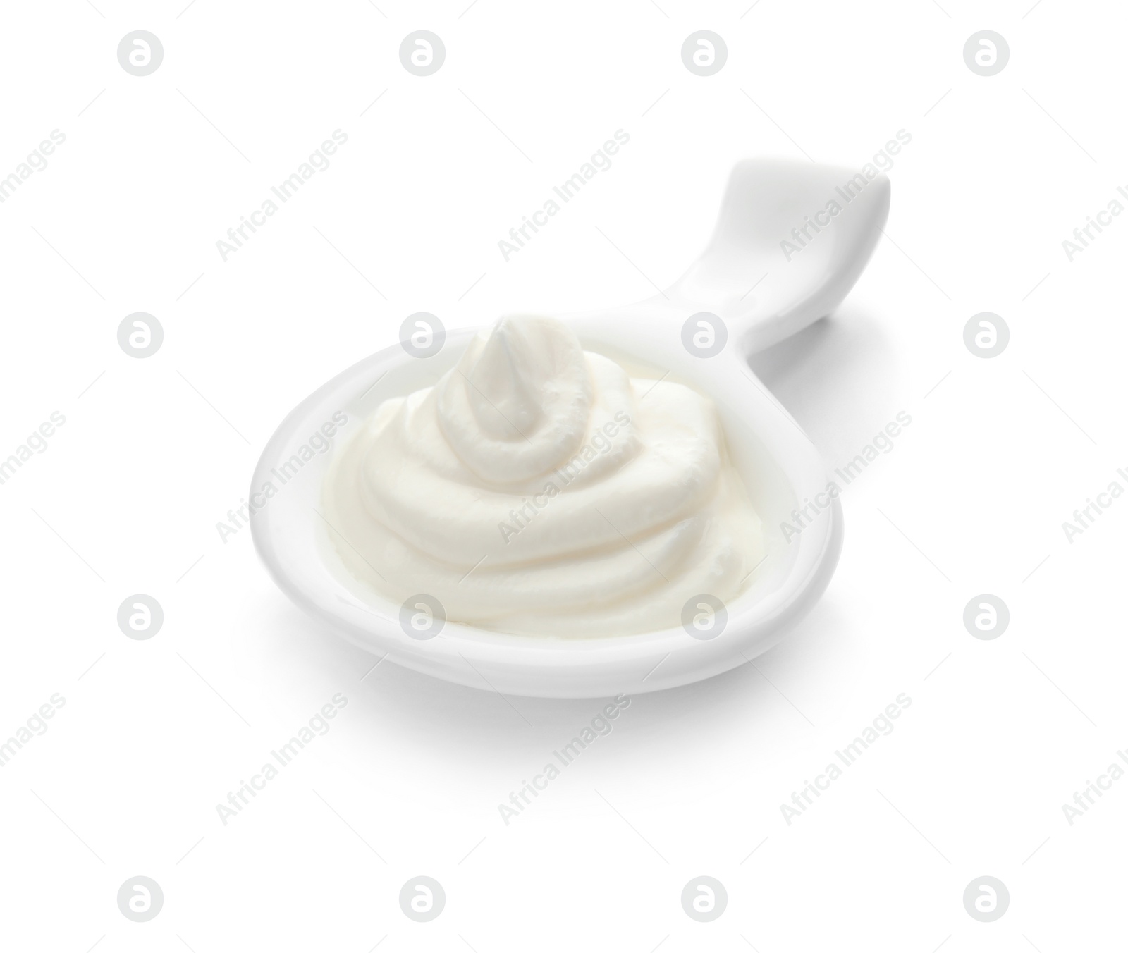 Photo of Serving spoon with sour cream on white background