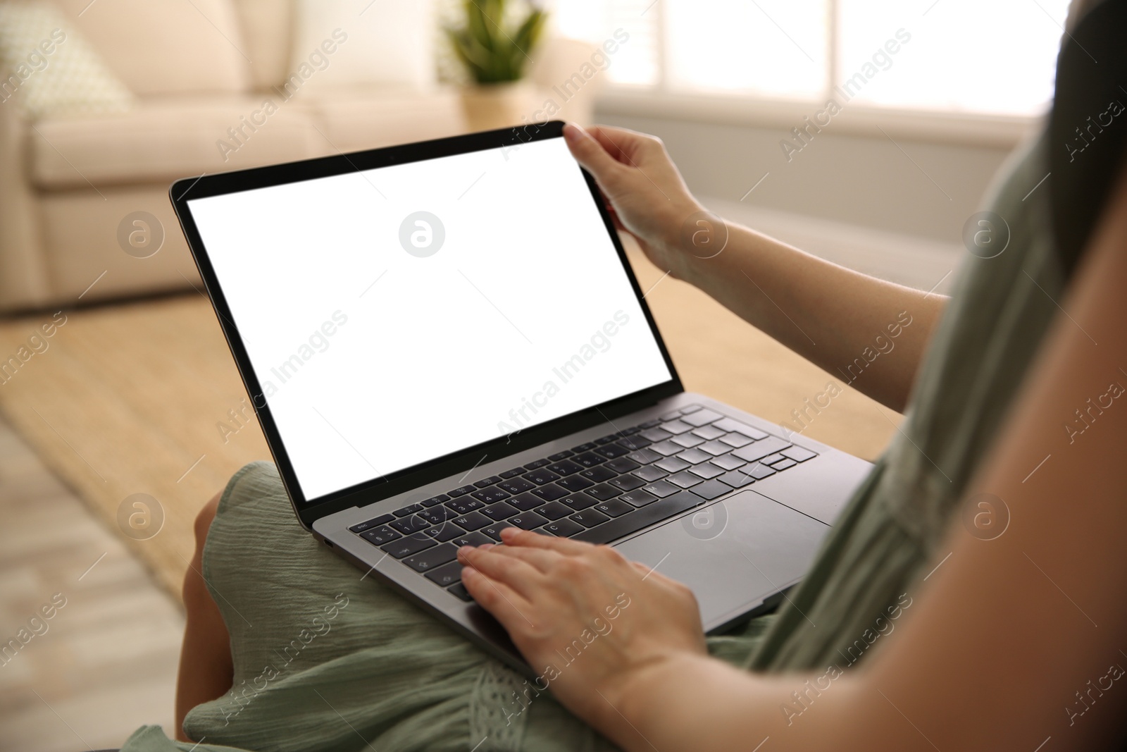 Photo of Woman using laptop at home, closeup. Space for design