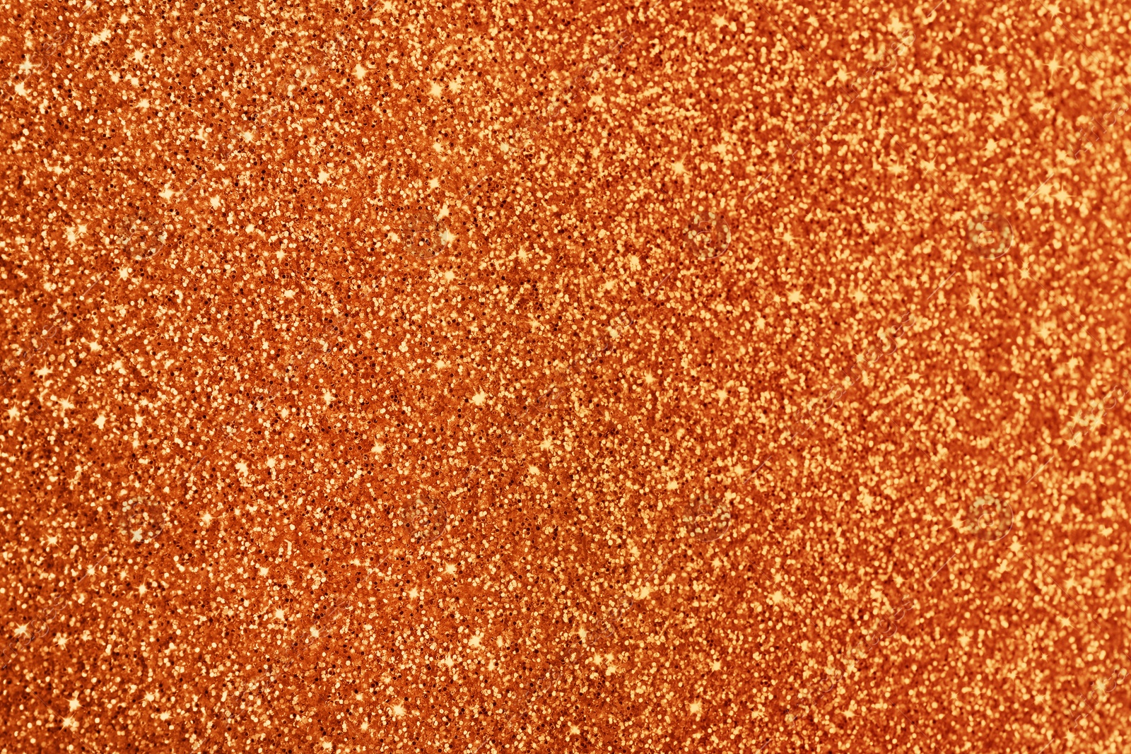 Image of Beautiful shiny orange glitter as background, closeup