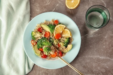 Photo of Salad with quinoa in plate on table, top view