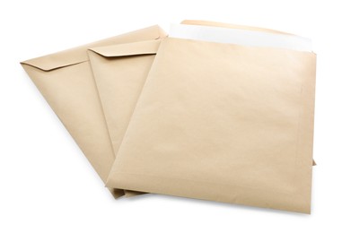 Photo of Many kraft paper envelopes on white background