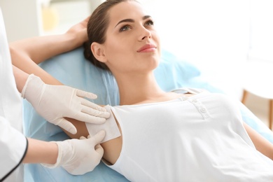 Photo of Woman getting wax epilation in salon