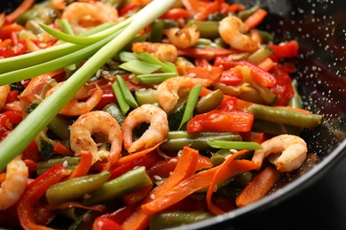 Shrimp stir fry with vegetables in wok, closeup