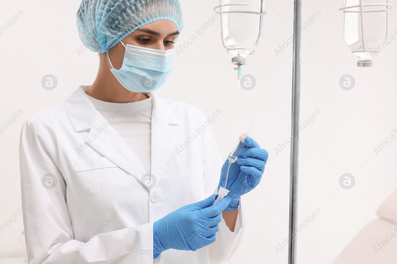 Photo of Nurse setting up IV drip in hospital