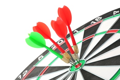 Photo of Dart board with color arrows hitting target, closeup