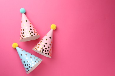 Photo of Beautiful party hats on pink background, top view. Space for text