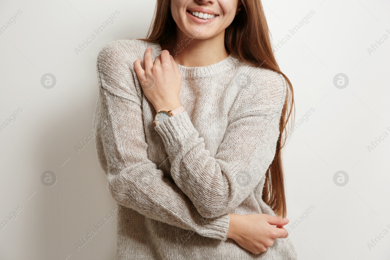 Photo of Beautiful young woman in warm sweater on white background