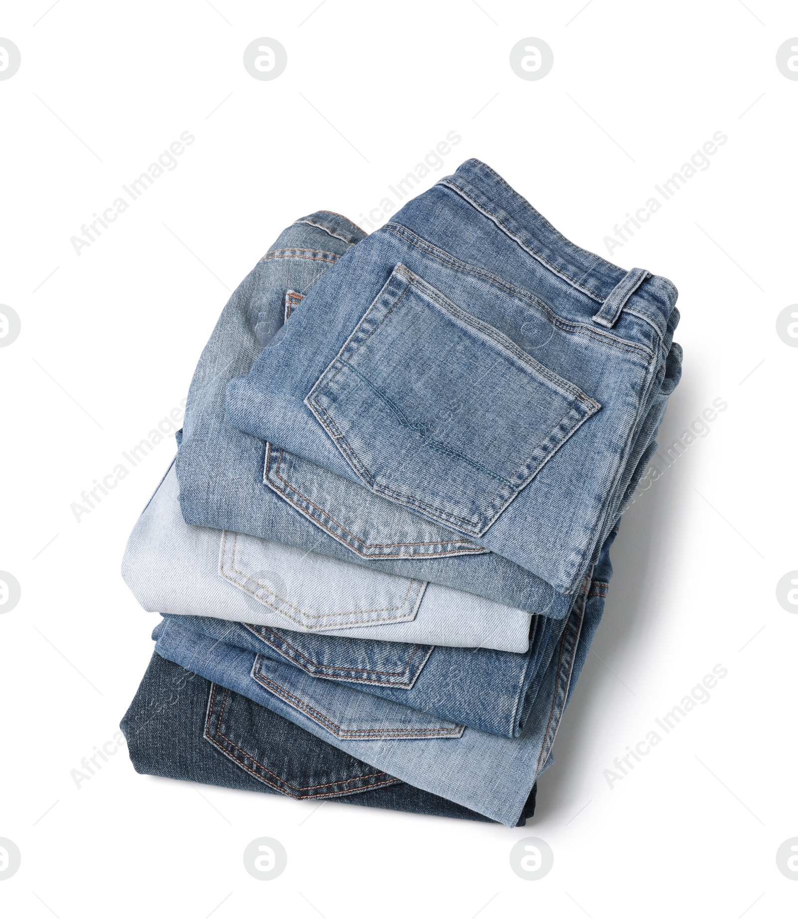 Image of Stack of different folded jeans isolated on white