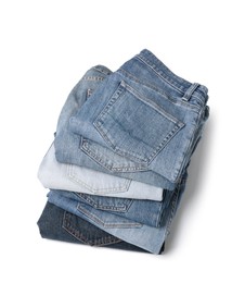 Image of Stack of different folded jeans isolated on white