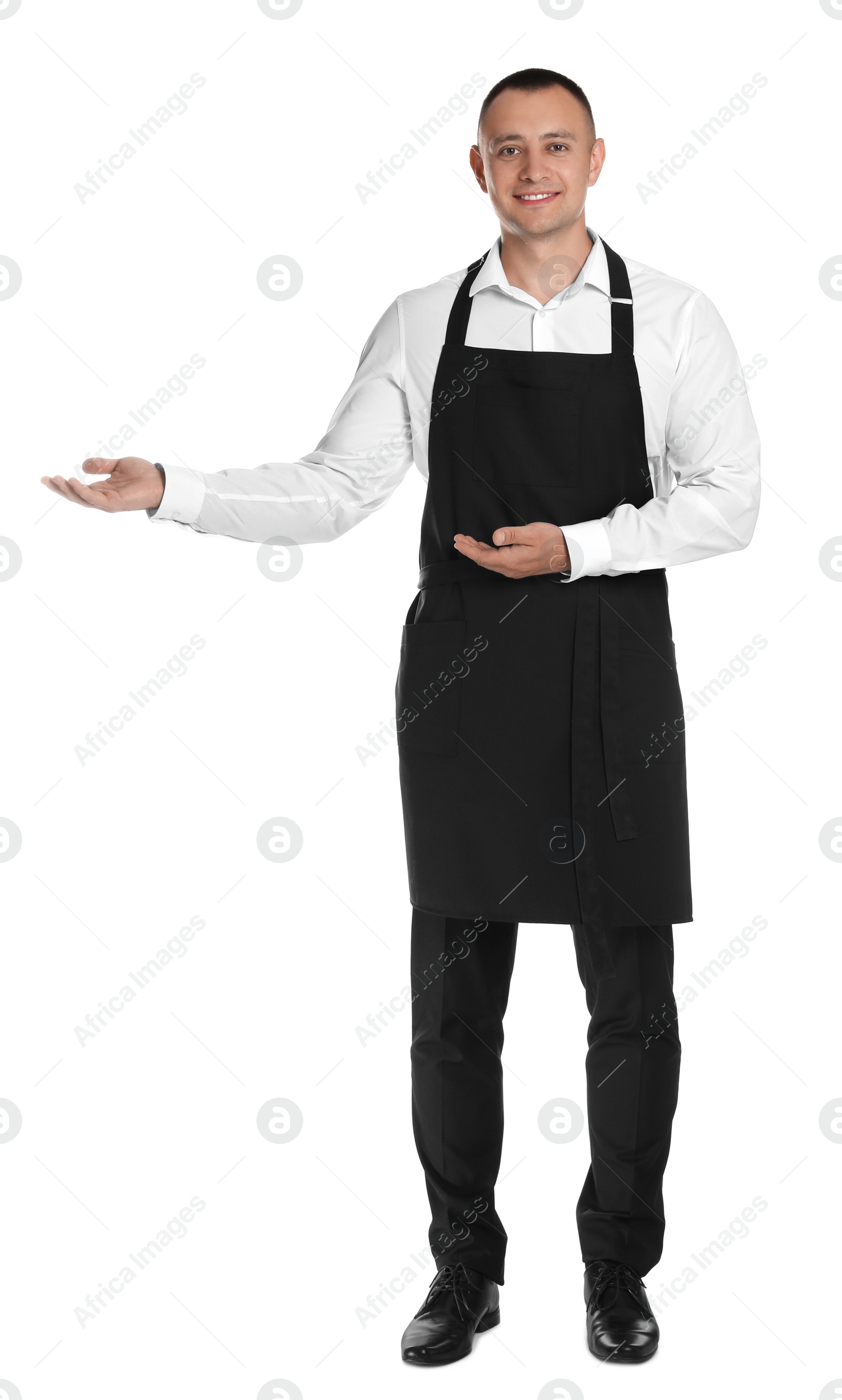 Photo of Full length portrait of happy young waiter in uniform on white background