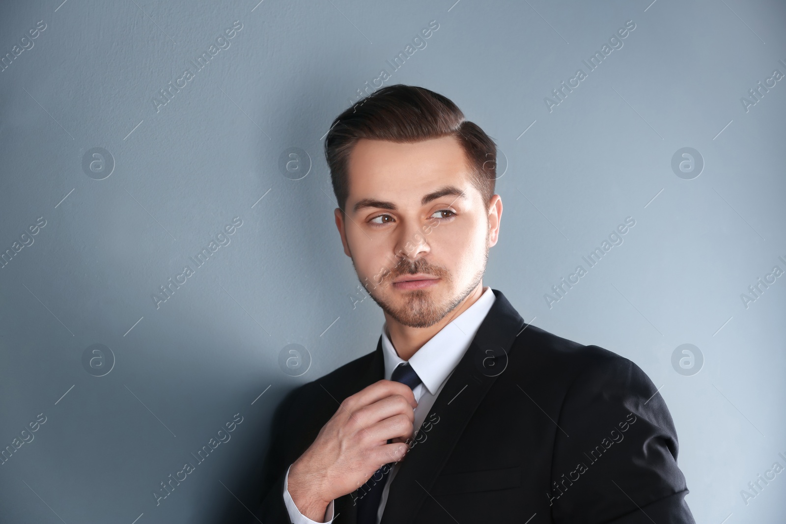 Photo of Portrait of young man with beautiful hair on grey background