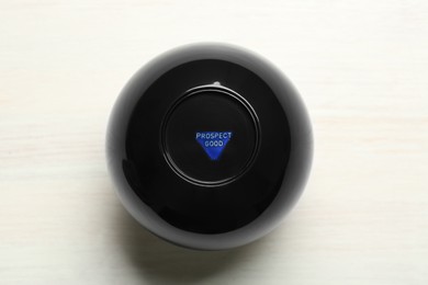 Photo of Magic eight ball with prediction Prospect Good on white table, top view