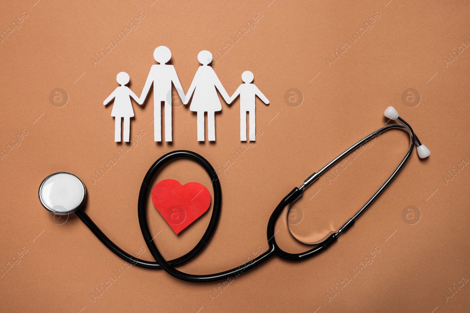 Photo of Paper family figures, red heart and stethoscope on brown background, flat lay. Insurance concept
