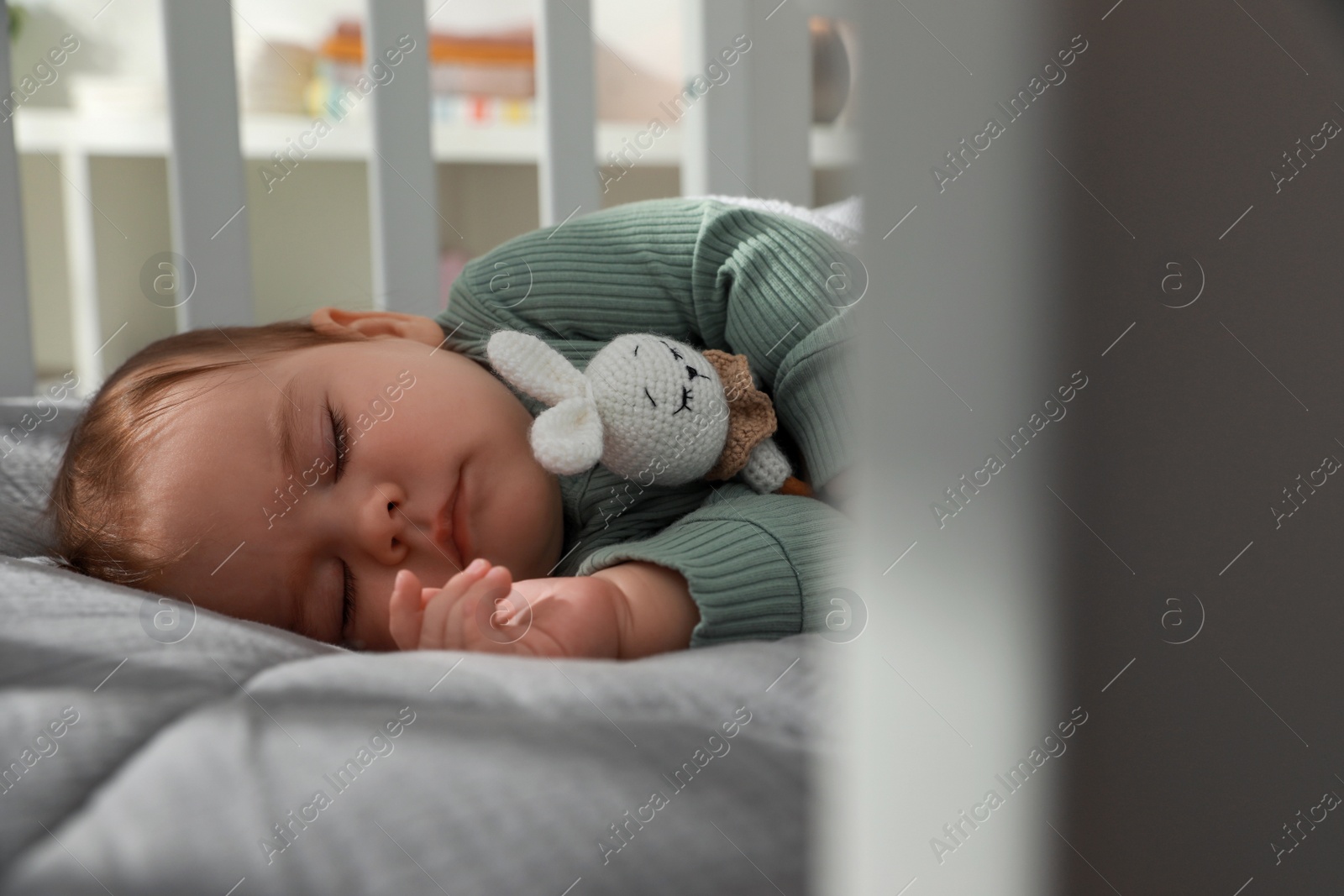 Photo of Cute little baby sleeping in crib at home. Bedtime