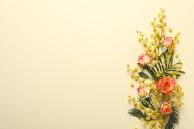 Photo of Beautiful floral composition with mimosa flowers on beige background, flat lay. Space for text