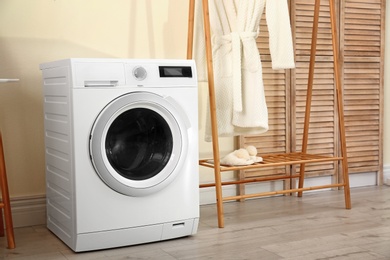 Photo of Laundry room interior with modern washing machine