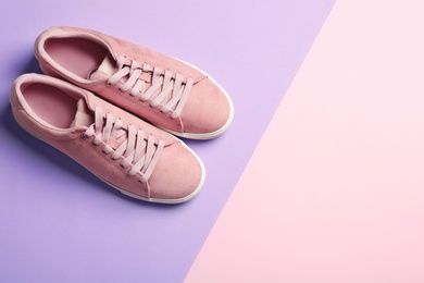 Photo of Bright stylish shoes on color background, top view. Space for text