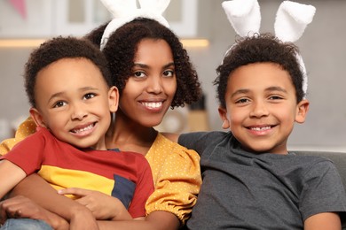 Photo of Happy African American mother and her cute children indoors