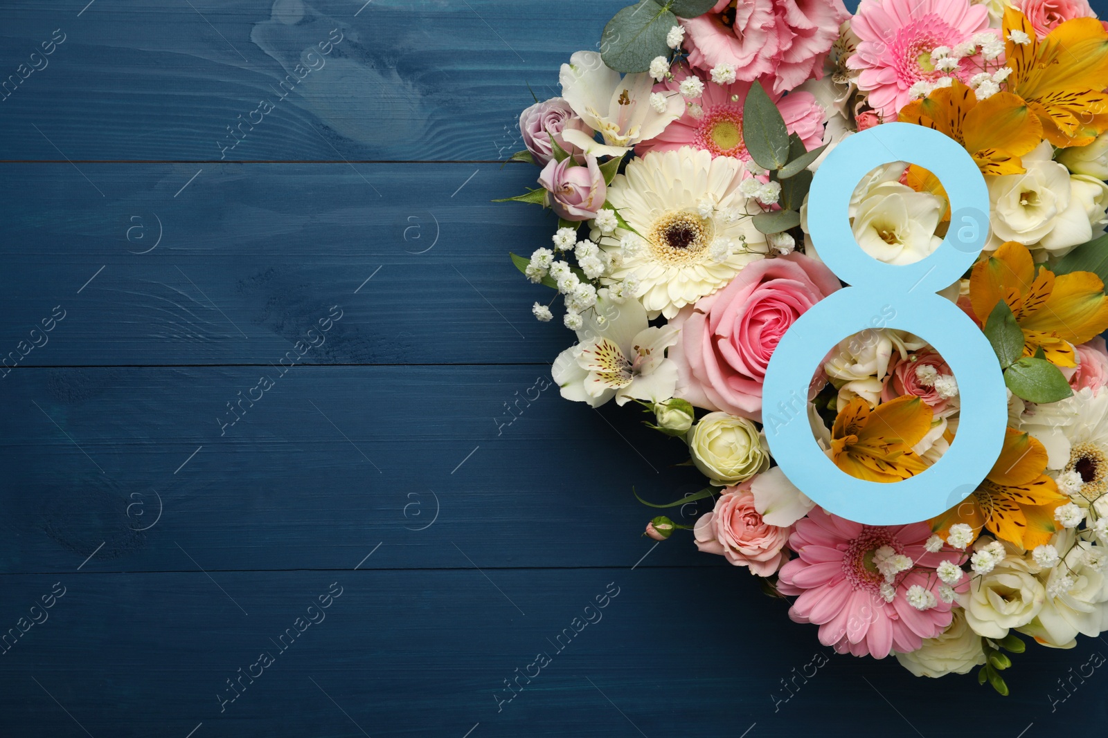 Photo of 8 March greeting card design with beautiful flowers on blue wooden table, flat lay and space for text. International Women's day