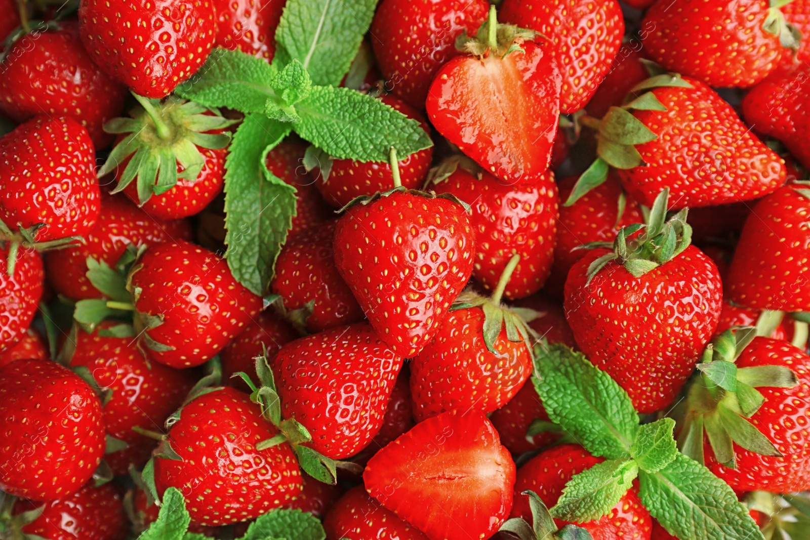 Photo of Ripe red strawberries and mint as background