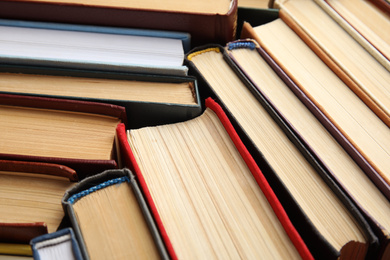 Many different hardcover books as background, closeup