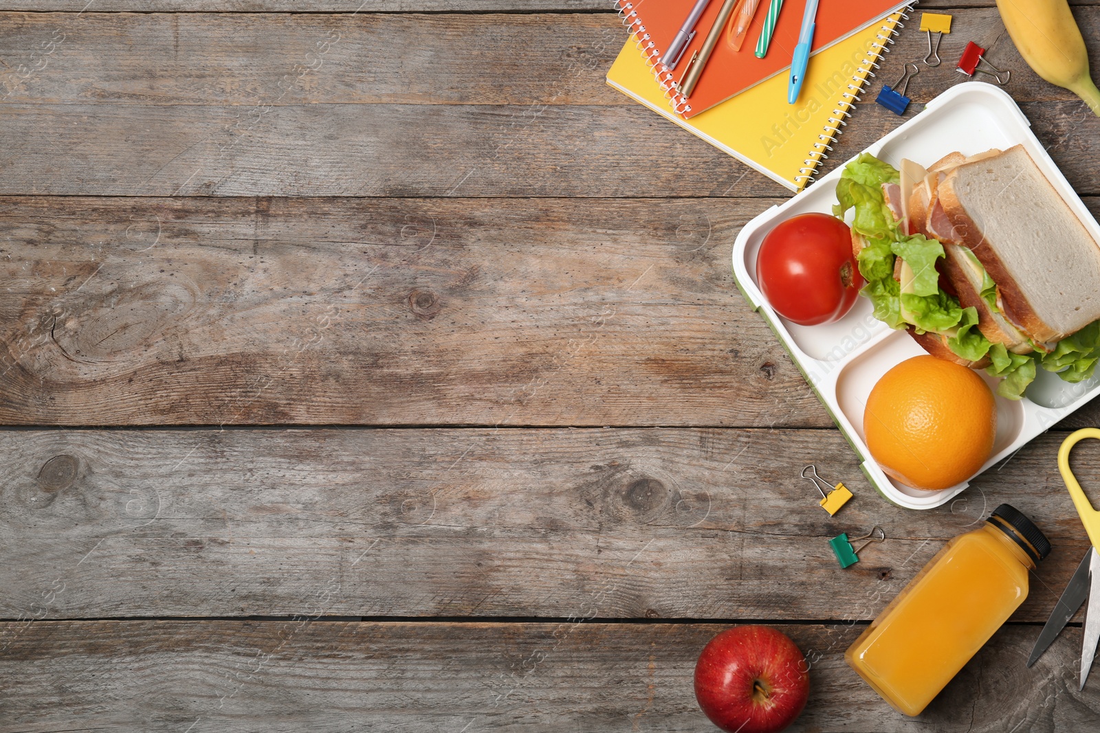 Photo of Flat lay composition with healthy food for school child and space for text on wooden background