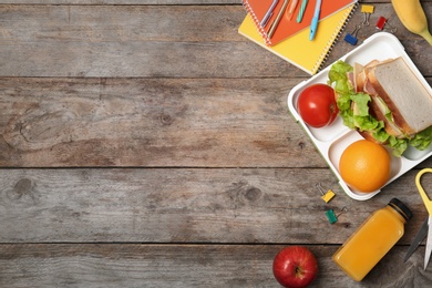 Flat lay composition with healthy food for school child and space for text on wooden background