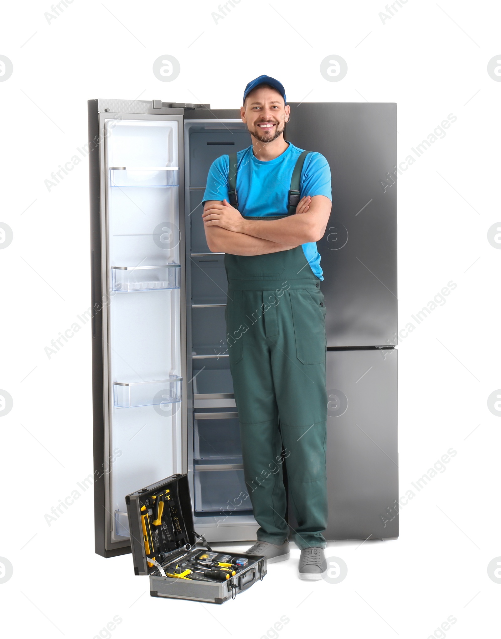 Photo of Male technician with tool box near refrigerator on white background