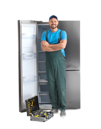 Photo of Male technician with tool box near refrigerator on white background