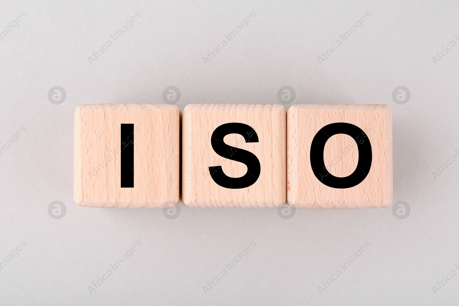 Photo of International Organization for Standardization. Cubes with abbreviation ISO on light grey background, top view