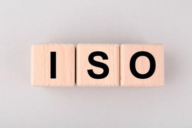 International Organization for Standardization. Cubes with abbreviation ISO on light grey background, top view