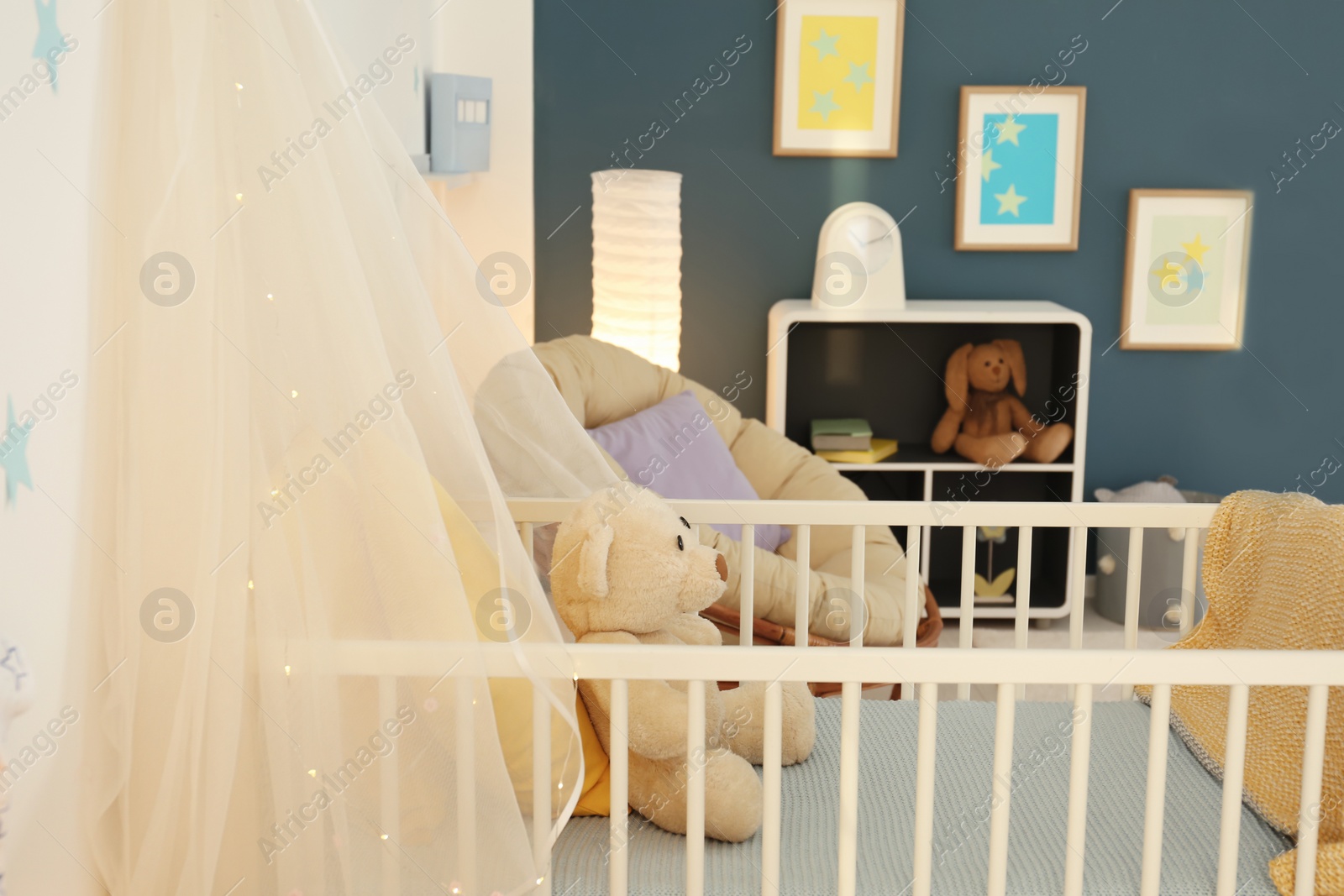 Photo of Stylish baby room interior with crib