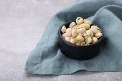 Photo of Sprouted kidney beans in bowl on light grey table, closeup. Space for text