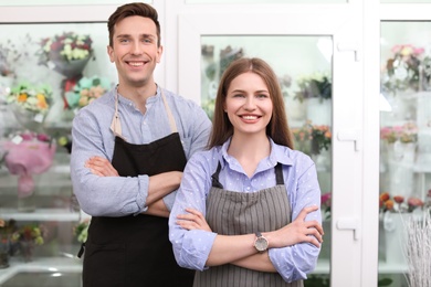 Male and female florists in flower shop