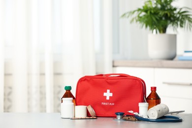 Photo of First aid kit on table indoors, space for text