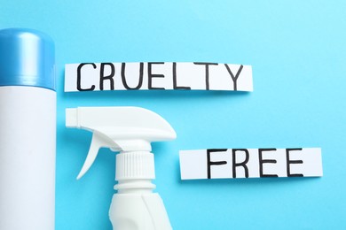Photo of Words Cruelty Free and detergents not tested on animals against light blue background, flat lay