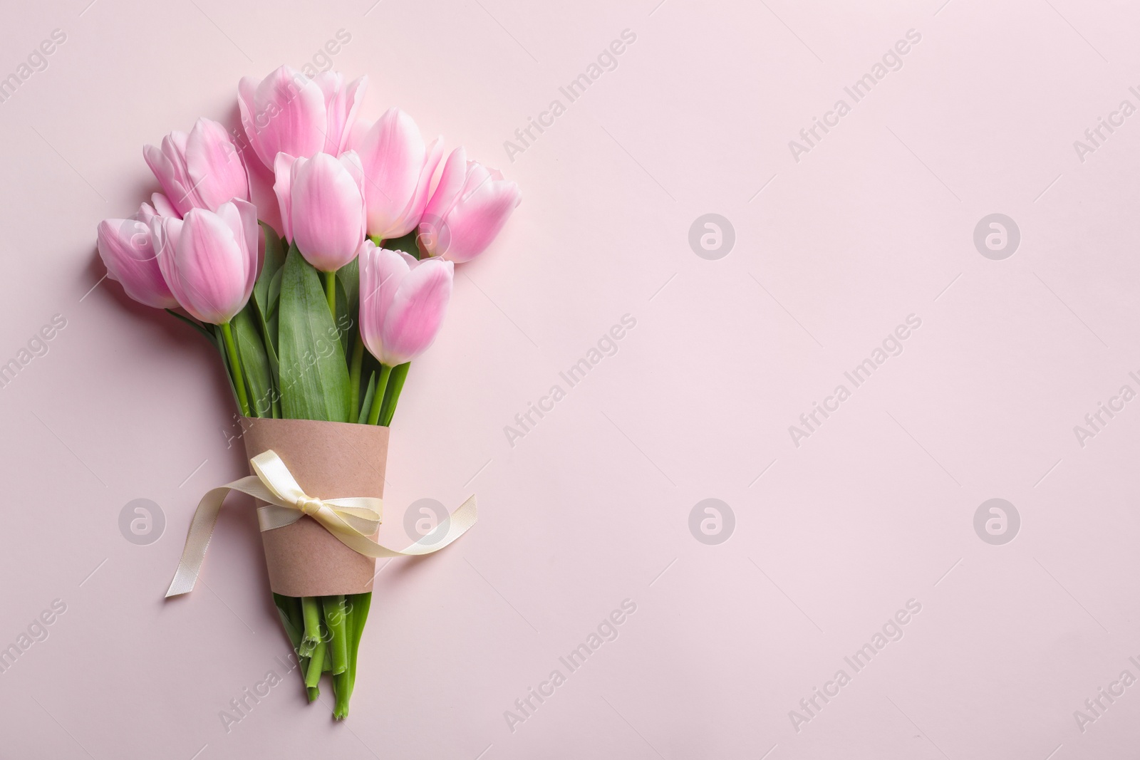 Photo of Beautiful tulips for Mother's Day on light background, top view