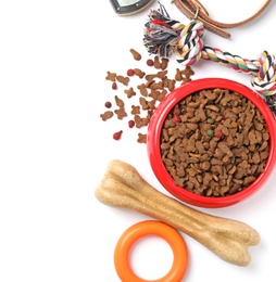 Bowl with food for dog and accessories on white background. Pet care