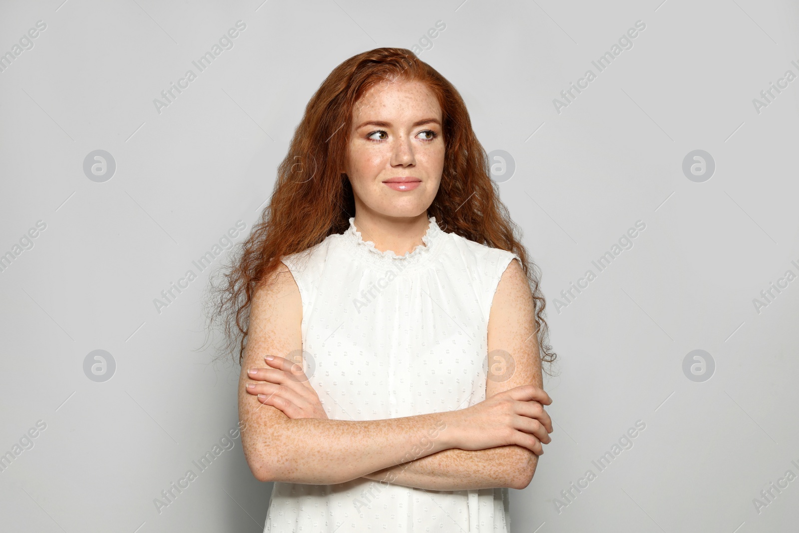 Photo of Portrait of young woman with beautiful face on grey background