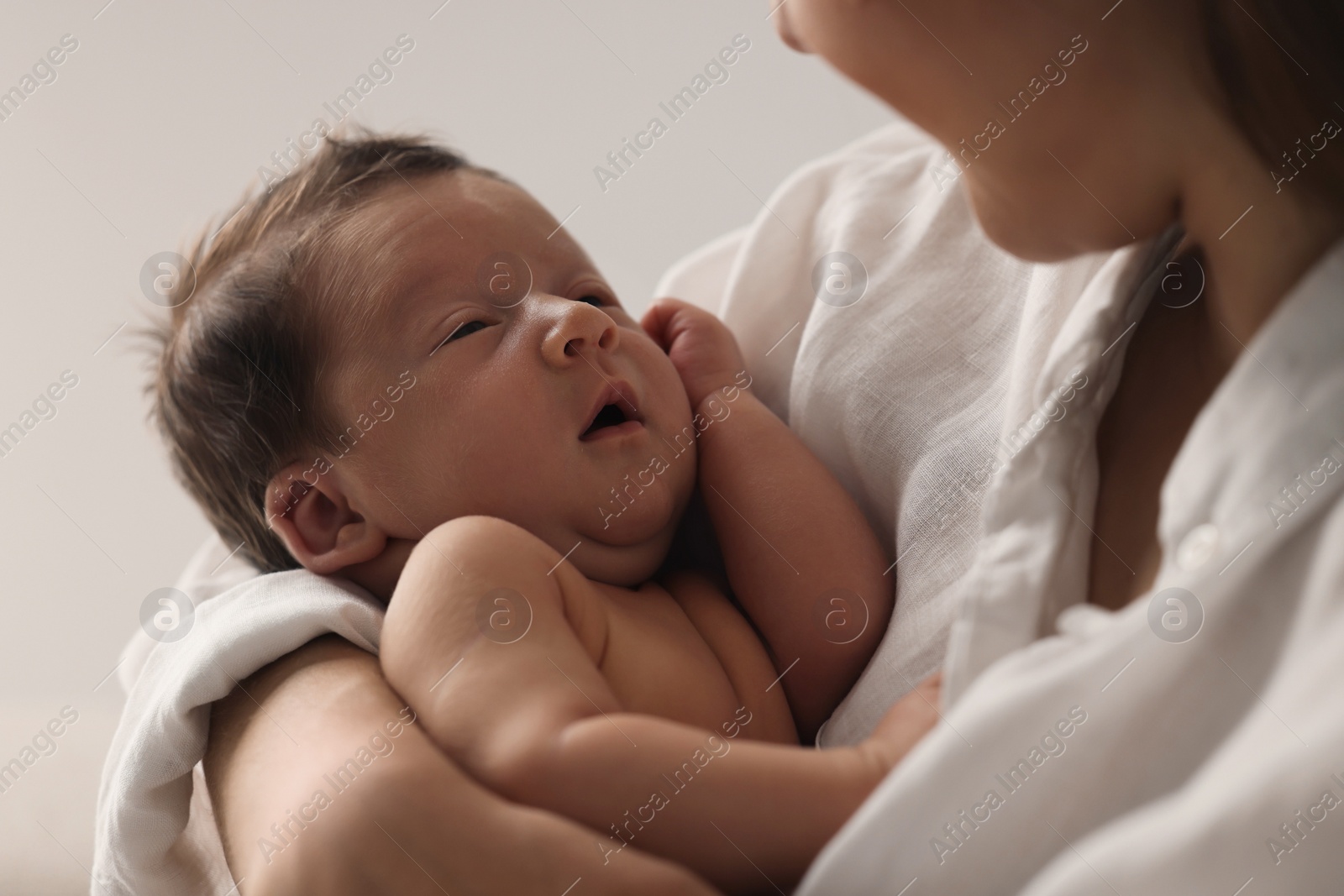 Photo of Mother holding her cute newborn baby, closeup