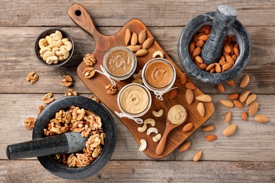 Photo of Making nut butters from different nuts. Fat lay composition on wooden table