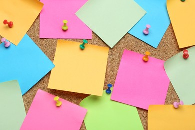 Photo of Many blank colorful notes pinned to corkboard. Space for text