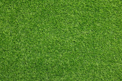 Photo of Green artificial grass as background, top view